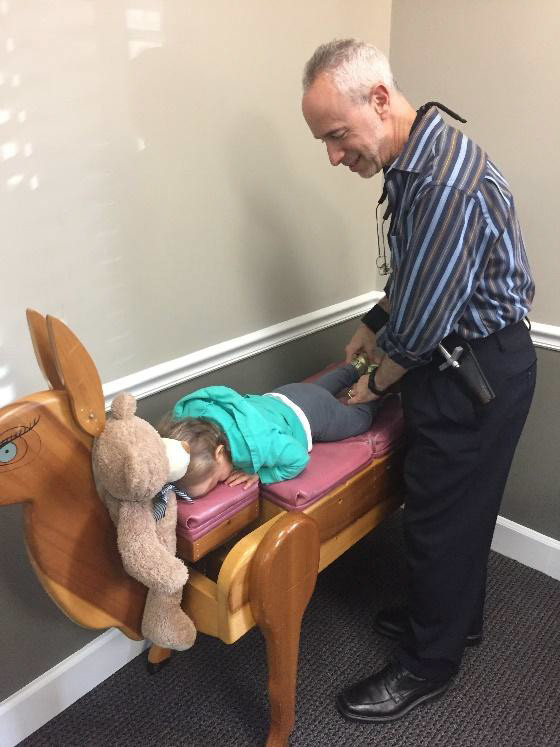 Kids love getting adjusted on the deer table made by his mentor, Dr. Larry Webster